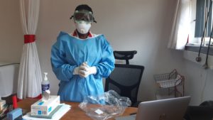 Dr. Ruth Mulwa at the Amref medical clinic located at Kenya Country Office showcases the protective gear.
