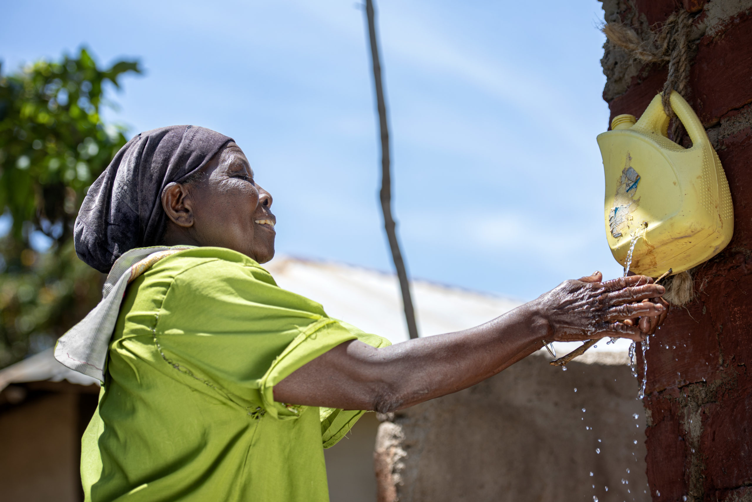 woman gathering water from a temporary water station.